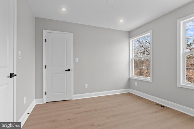 unfurnished bedroom featuring light wood-style flooring, visible vents, baseboards, and recessed lighting