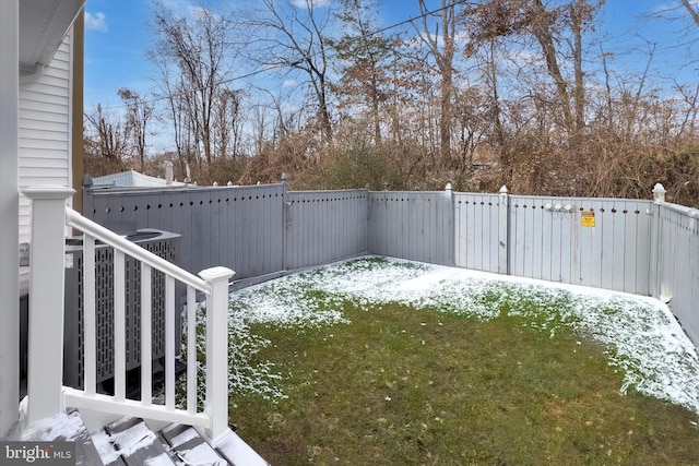 yard layered in snow featuring a fenced backyard