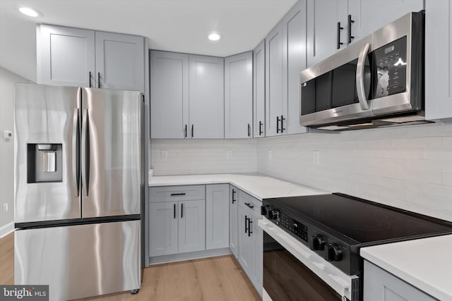 kitchen with light countertops, appliances with stainless steel finishes, and light wood-type flooring