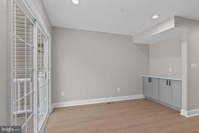 interior space with light wood finished floors, recessed lighting, and baseboards