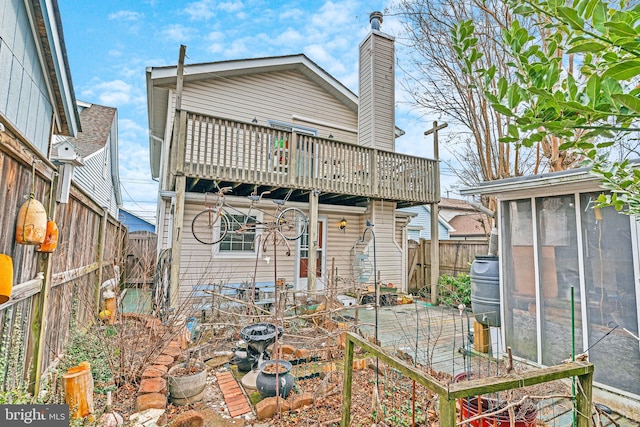 8322 Bayside Rd, Chesapeake Beach, MD 20732 - rear view of property featuring a fenced backyard, a sunroom, a balcony, and a chimney
