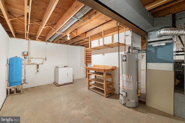 unfinished basement with gas water heater and fridge