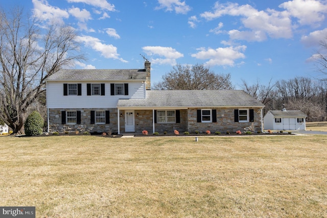 view of front of property featuring stone siding, a chimney, and a front yard