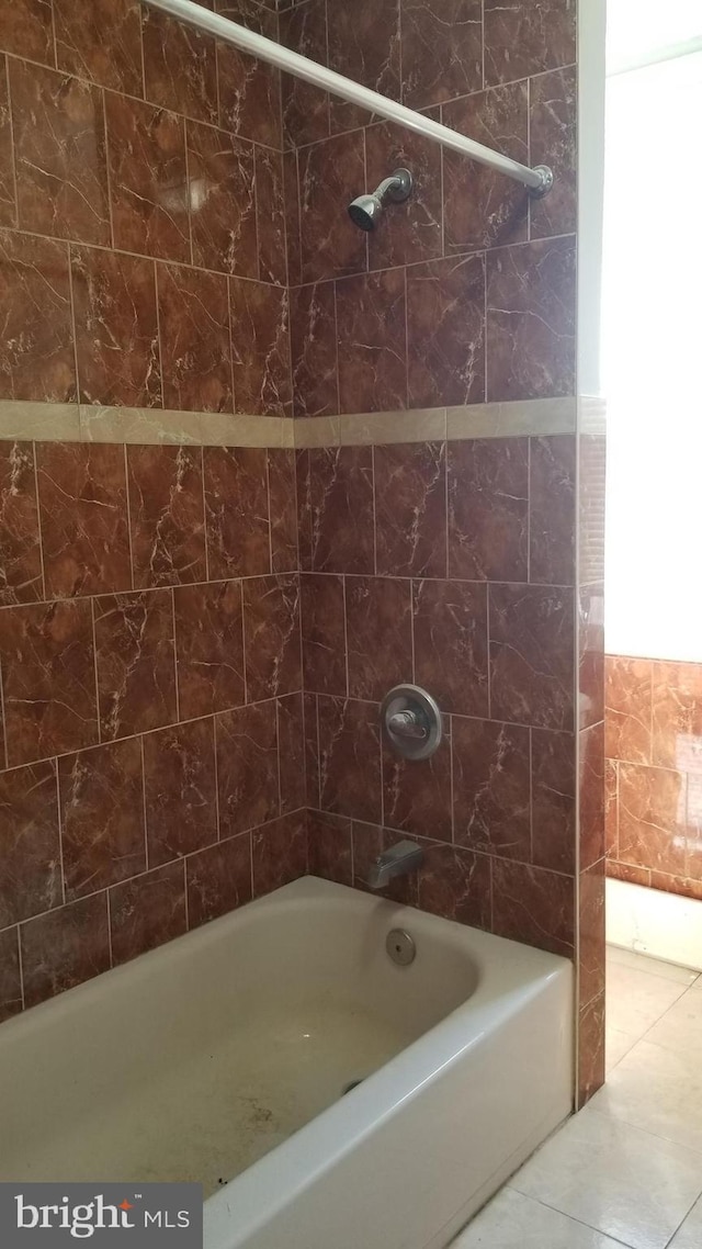 bathroom featuring tub / shower combination and tile patterned flooring