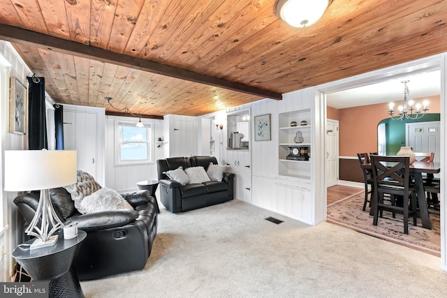 carpeted living area with arched walkways, a chandelier, wood ceiling, visible vents, and beam ceiling