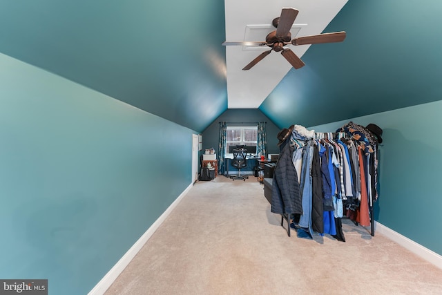 spacious closet with lofted ceiling, ceiling fan, and carpet flooring