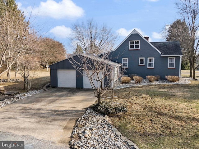 view of front of home featuring a shingled roof, concrete driveway, a chimney, and an attached garage