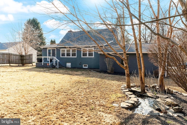 rear view of property with fence, a chimney, and stucco siding