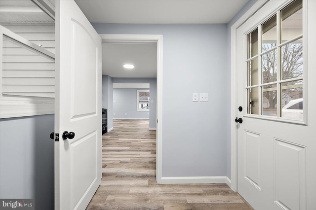 interior space featuring baseboards and wood finished floors