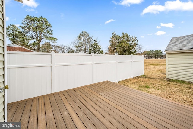 wooden deck with fence and a lawn