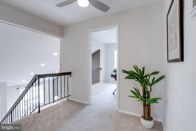 hallway featuring recessed lighting, carpet, an upstairs landing, and baseboards