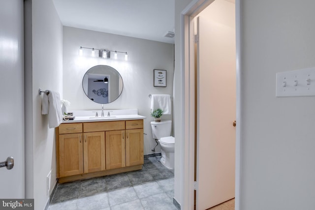 bathroom with toilet, visible vents, and vanity