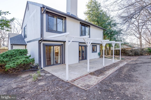 back of property with a chimney, a patio area, fence, and a pergola