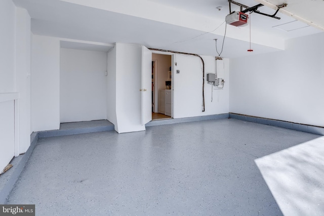 garage featuring independent washer and dryer and a garage door opener