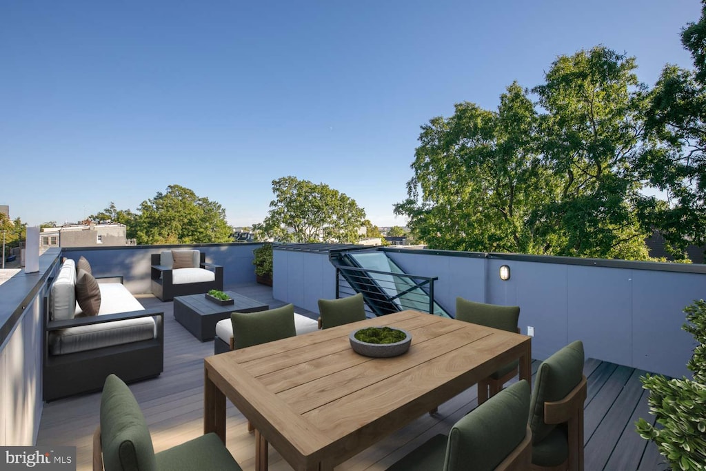 wooden deck featuring outdoor dining area and an outdoor hangout area