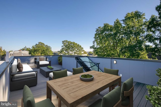 wooden deck featuring outdoor dining area and an outdoor hangout area