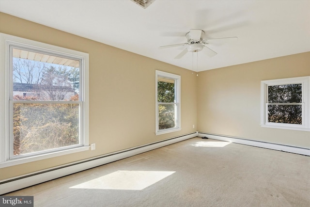 carpeted empty room with a baseboard heating unit and ceiling fan