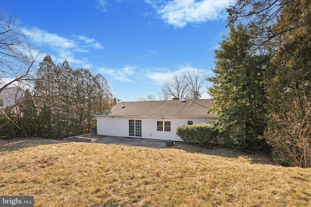 back of house featuring a patio area and a lawn