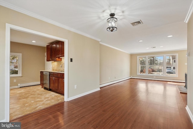 unfurnished living room featuring visible vents, light wood-style flooring, baseboard heating, ornamental molding, and baseboards