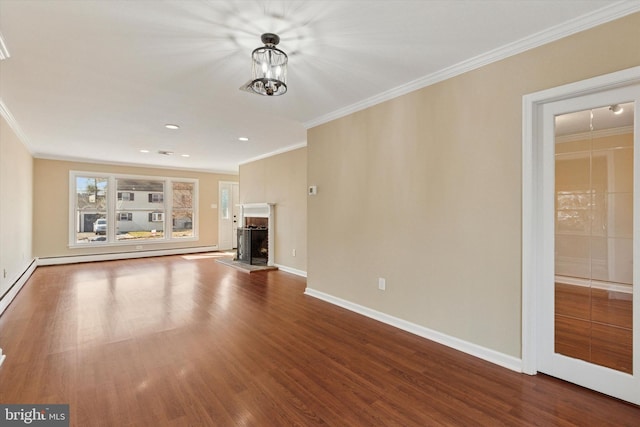 unfurnished living room with ornamental molding and wood finished floors