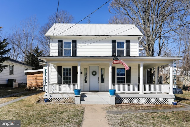 farmhouse inspired home with metal roof, a porch, and cooling unit