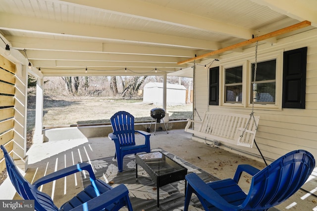 exterior space featuring an outbuilding, a patio area, grilling area, and a storage unit