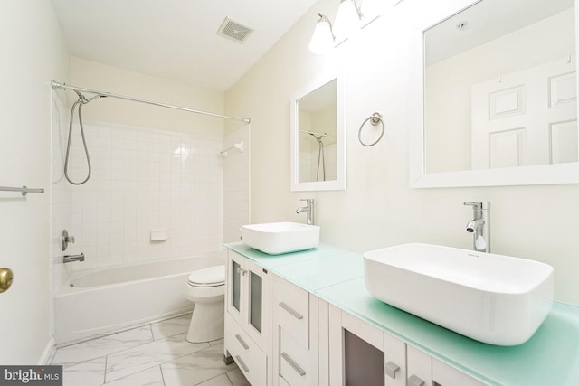 bathroom featuring marble finish floor, visible vents, a sink, and toilet