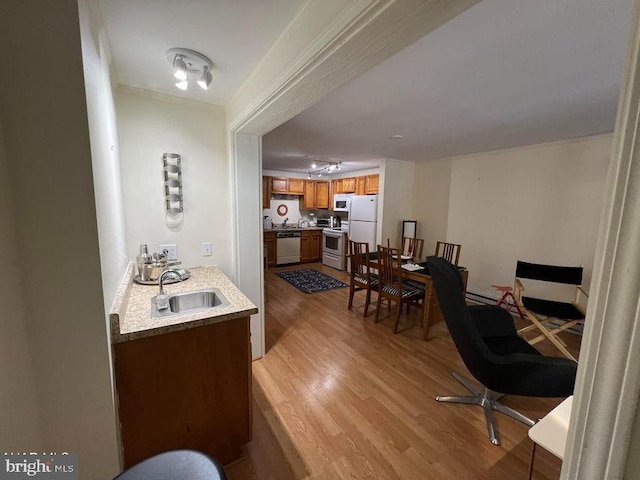 office space featuring a sink and light wood-style flooring