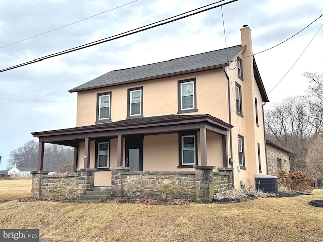 view of front of property with covered porch, a chimney, central air condition unit, and stucco siding