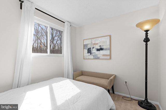 carpeted bedroom featuring baseboards