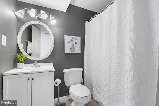 bathroom with tile patterned floors, toilet, vanity, and baseboards