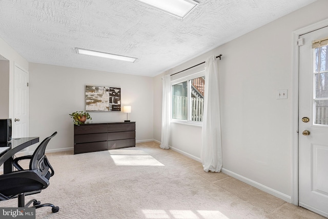 office with carpet, baseboards, and a textured ceiling