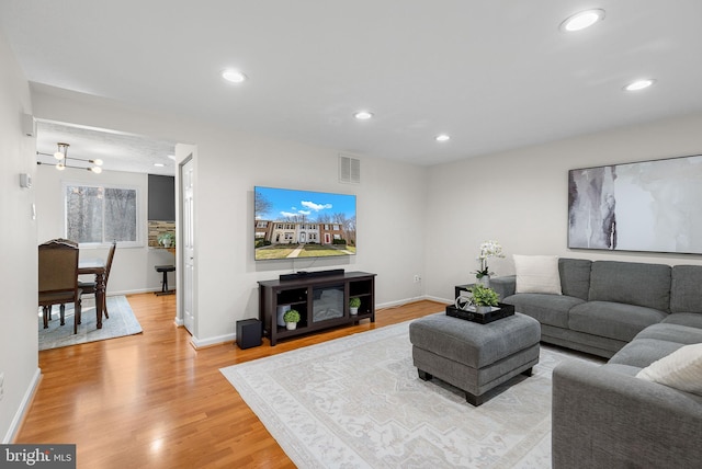 living area with recessed lighting, light wood-style floors, visible vents, and baseboards