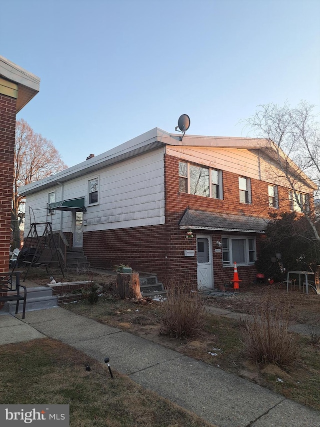 view of front of property featuring brick siding