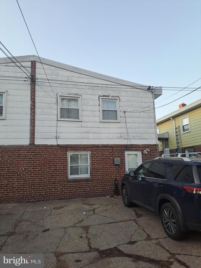 view of side of home featuring brick siding