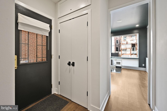 entryway featuring baseboards and wood finished floors