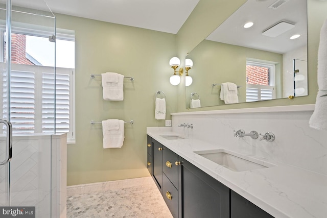 bathroom with double vanity, tile patterned flooring, visible vents, and a sink