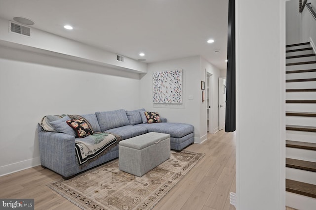 living area with stairway, visible vents, light wood finished floors, and recessed lighting