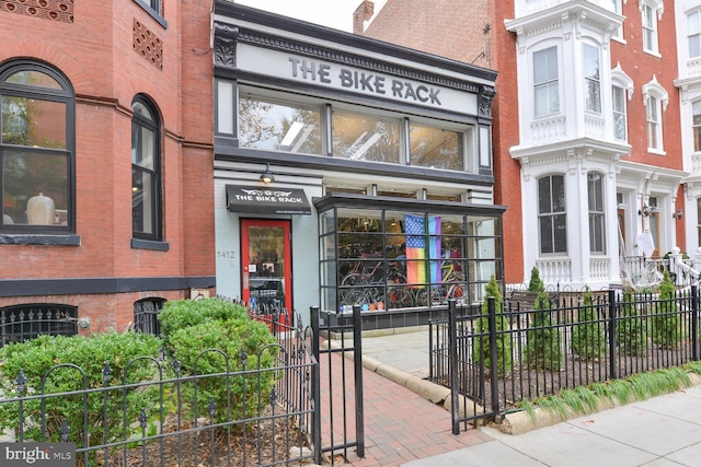 property entrance featuring brick siding and fence