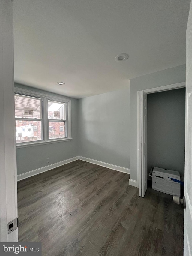 unfurnished bedroom featuring dark wood-style floors, recessed lighting, and baseboards