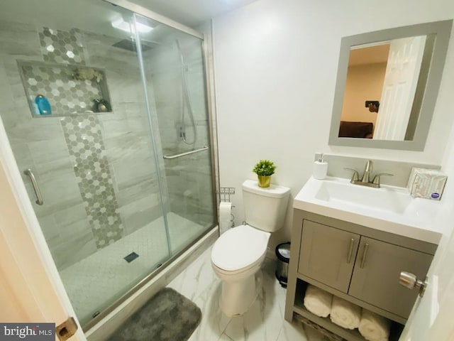 full bath with marble finish floor, vanity, toilet, and a shower stall