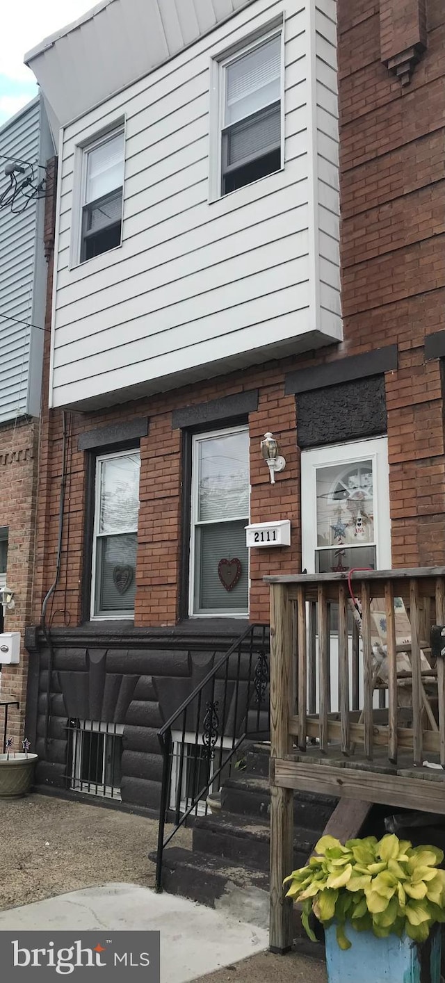 doorway to property with brick siding