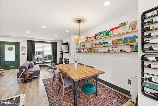 dining area with recessed lighting and light wood-style flooring