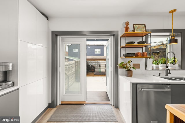 entryway featuring a sink and light wood finished floors