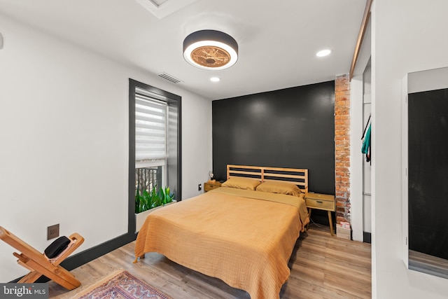 bedroom featuring recessed lighting, visible vents, and wood finished floors