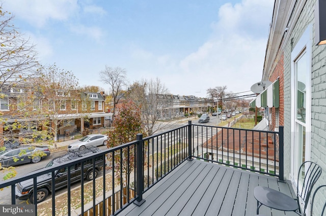 wooden deck featuring a residential view