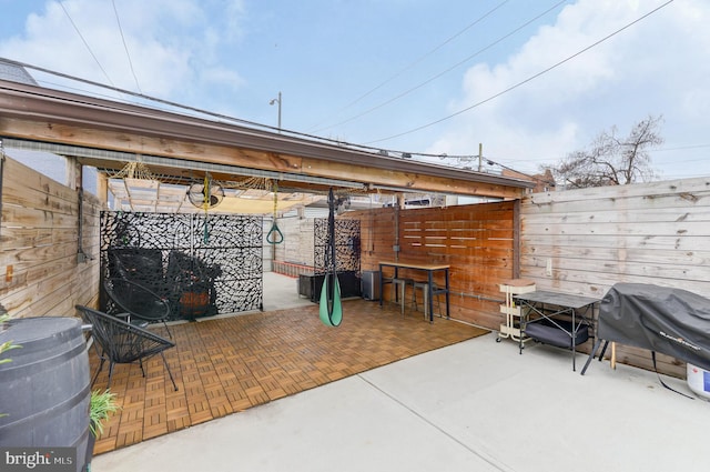 view of patio featuring a fenced backyard and outdoor dry bar