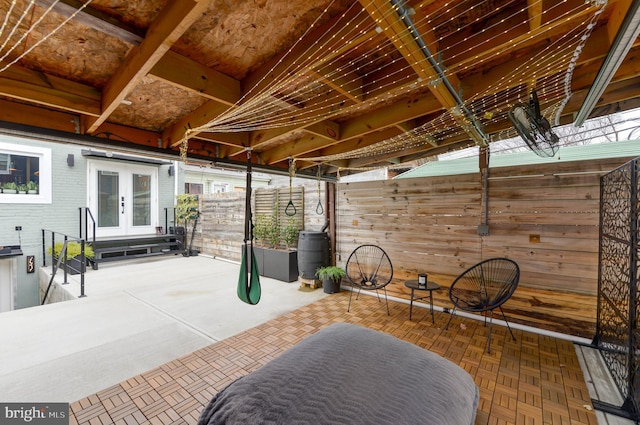 view of patio / terrace with fence, french doors, and entry steps