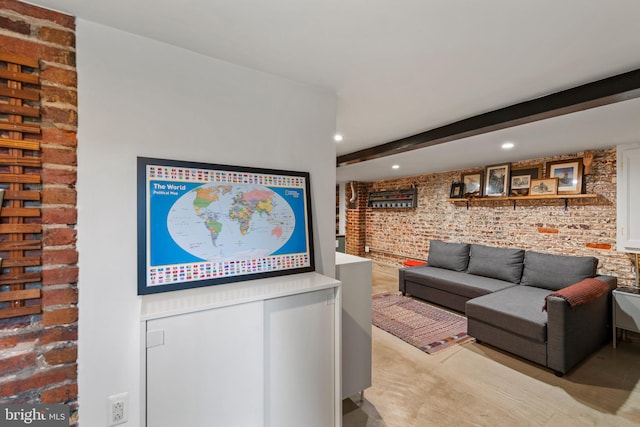 living room featuring recessed lighting, brick wall, and beamed ceiling