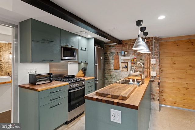 kitchen with a sink, stainless steel appliances, a toaster, and butcher block countertops
